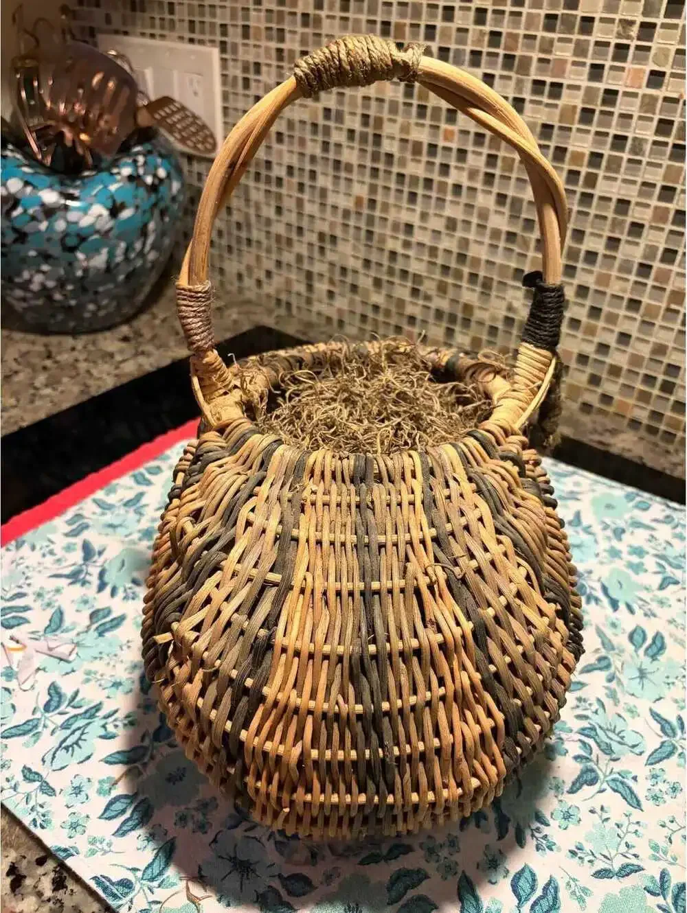 This is a vintage hand-woven double buttocks wicker harvest basket.